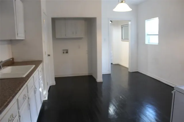 wooden floor in an empty room with a stove