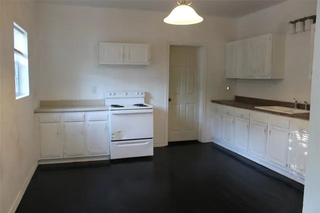 a kitchen with a sink and cabinets