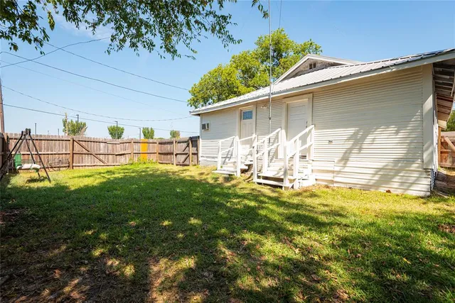 a house view with swimming pool in front of it