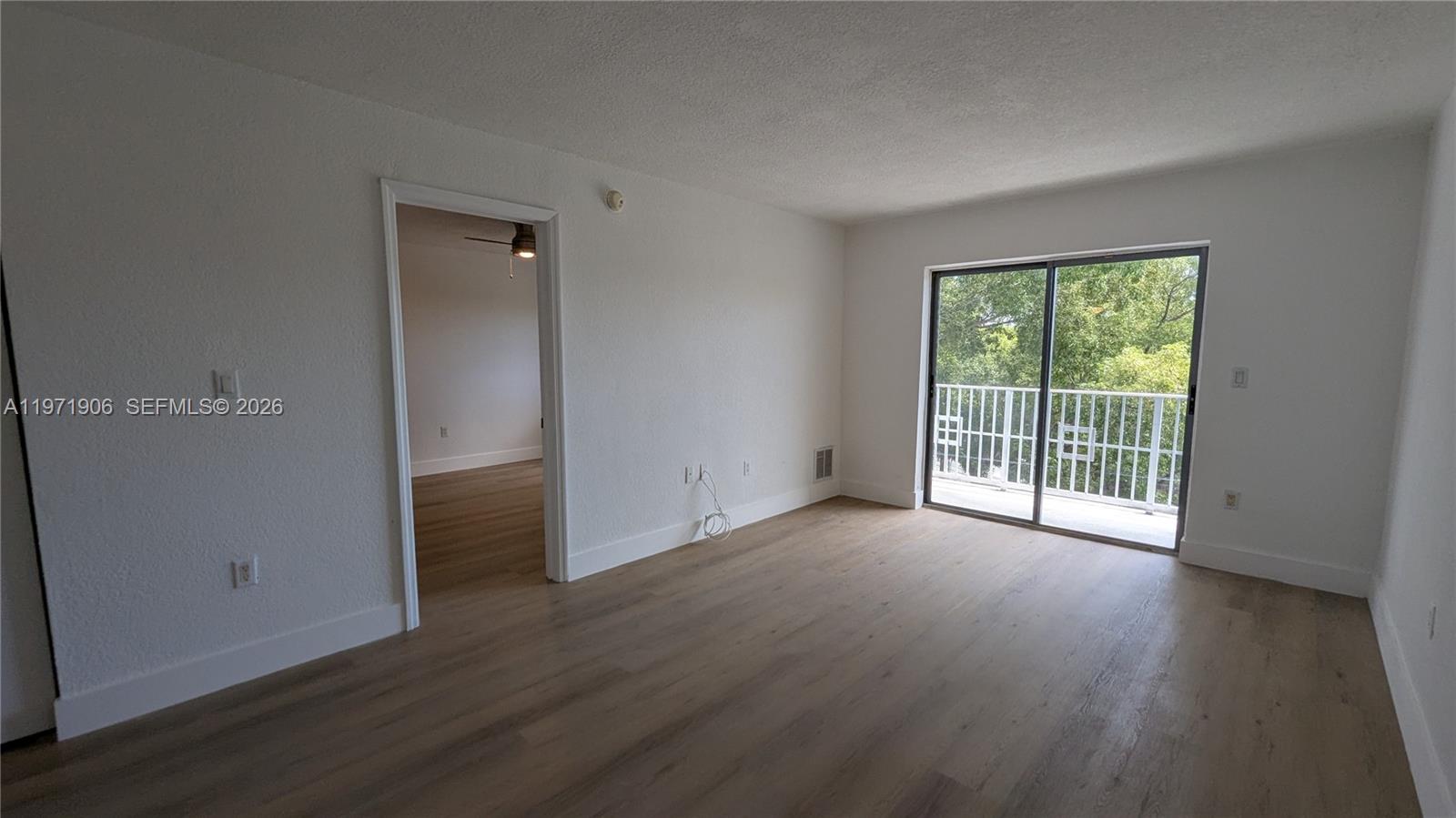 445 Southwest 11th Street, Unit 408 Miami, FL 33130 - Photo 14 of 29 an empty room with wooden floor and windows