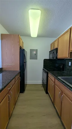 a kitchen with a sink a window and cabinets