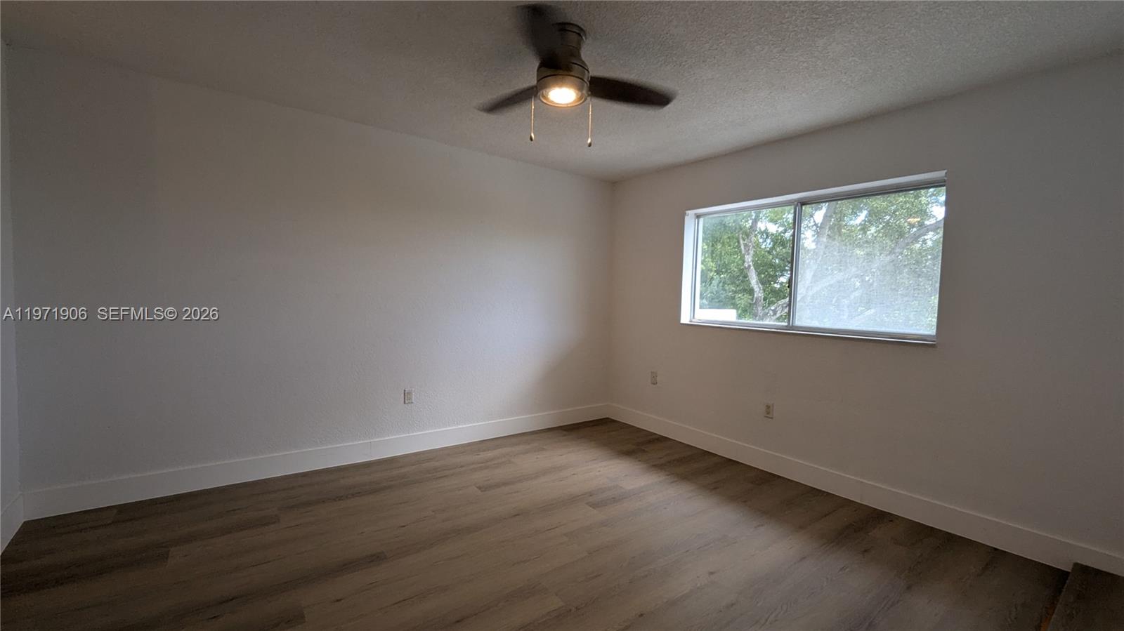 445 Southwest 11th Street, Unit 408 Miami, FL 33130 - Photo 20 of 29 a view of an empty room with wooden floor and a window