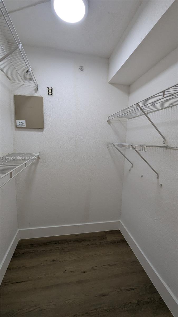 445 Southwest 11th Street, Unit 408 Miami, FL 33130 - Photo 24 of 29 a view of a room with wooden floor and exposed radiator