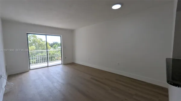 a view of a room with wooden floor and exposed radiator