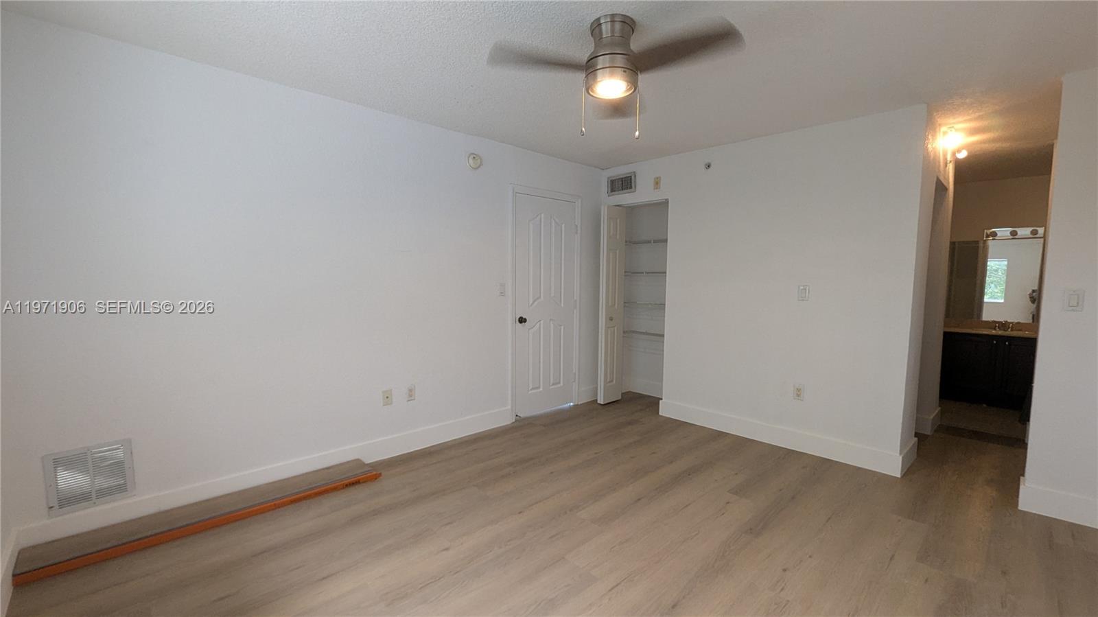 445 Southwest 11th Street, Unit 408 Miami, FL 33130 - Photo 29 of 29 an empty room with a empty space and a ceiling fan