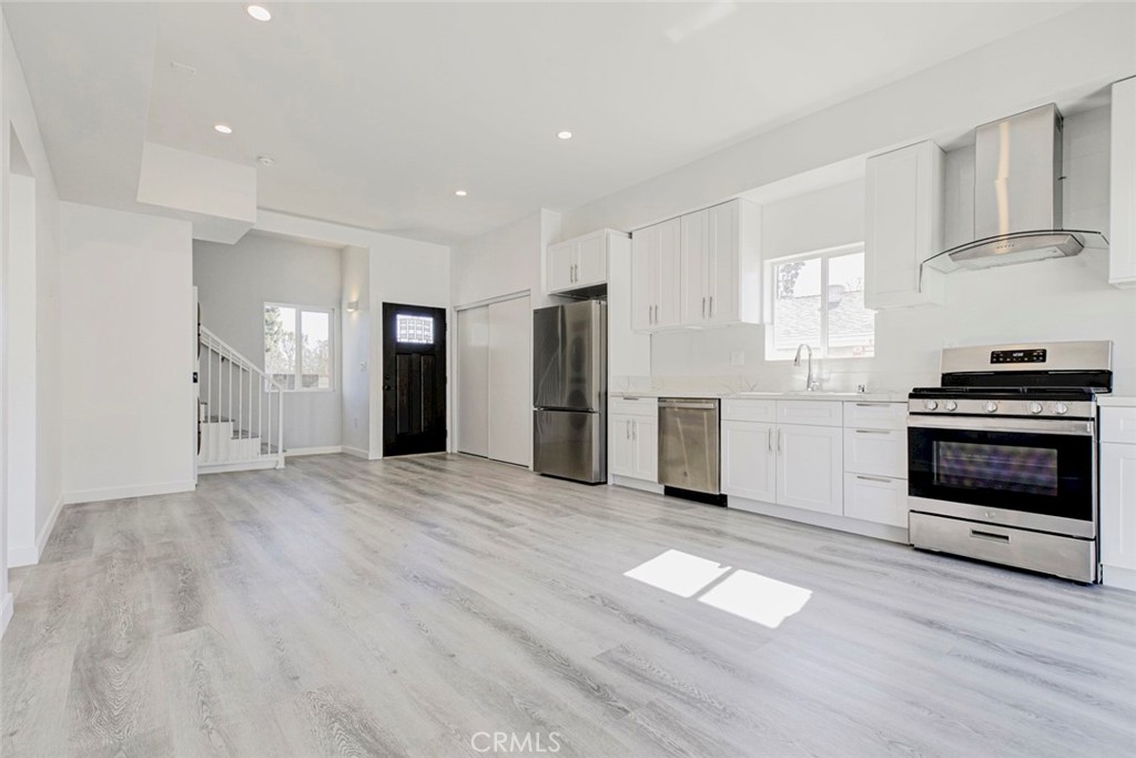 10499 Yolanda Avenue Porter Ranch, CA 91326 - Photo 12 of 37 a view of a kitchen with wooden floor and electronic appliances
