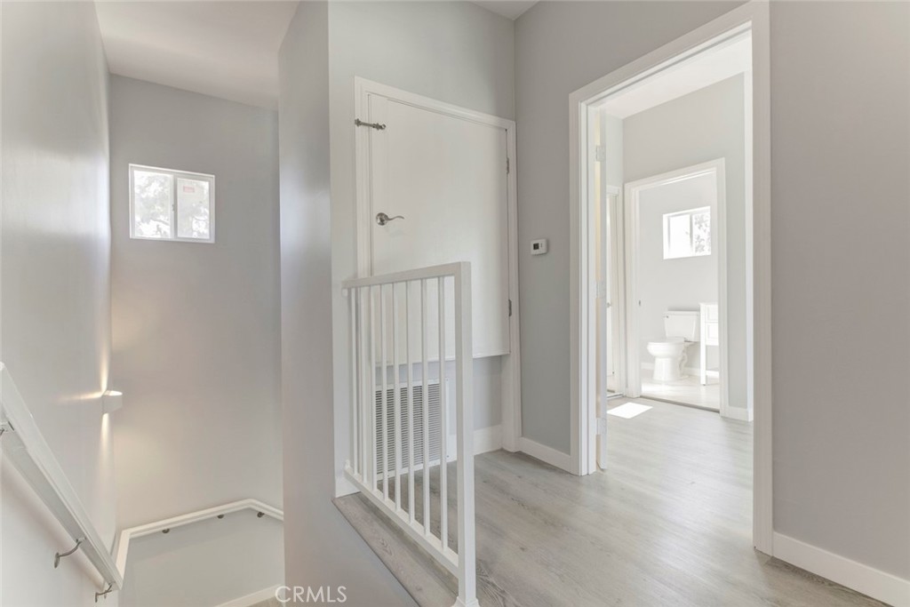 10499 Yolanda Avenue Porter Ranch, CA 91326 - Photo 22 of 37 a view of a hallway with wooden floor and a bathroom