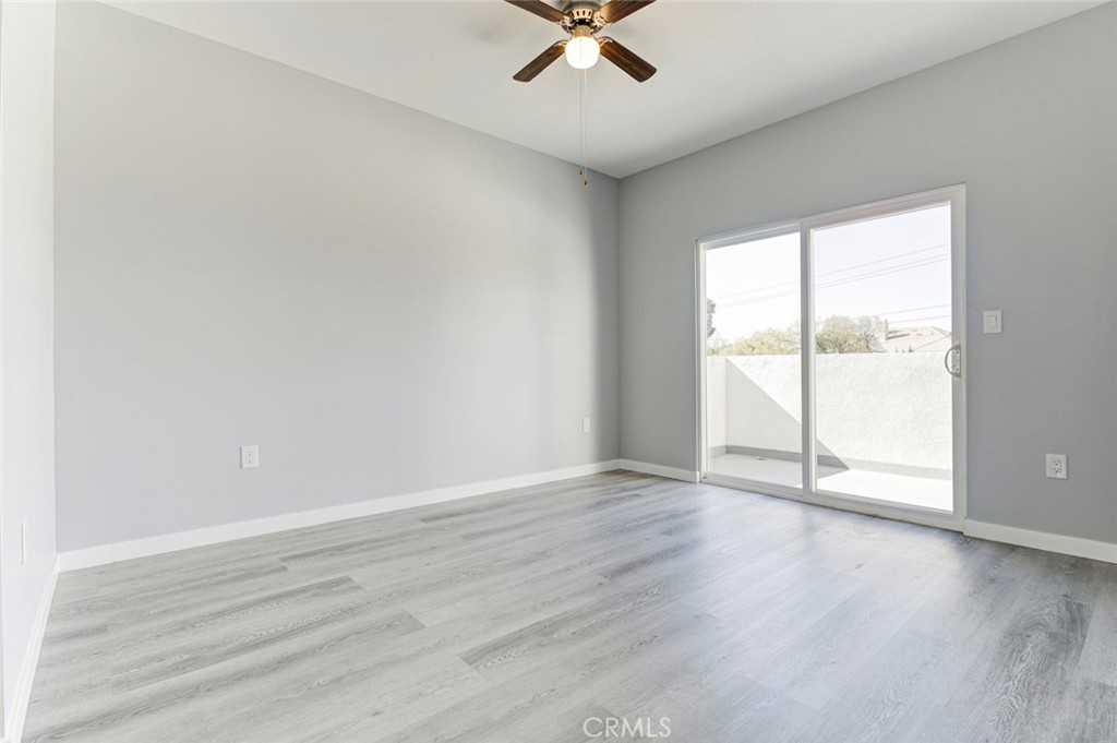 10499 Yolanda Avenue Porter Ranch, CA 91326 - Photo 27 of 37 an empty room with wooden floor and windows