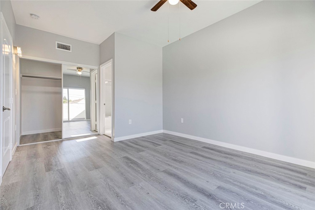10499 Yolanda Avenue Porter Ranch, CA 91326 - Photo 28 of 37 a view of an empty room with wooden floor and a window