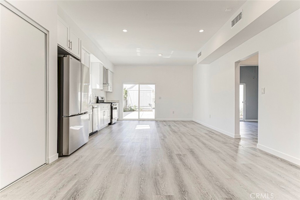 10499 Yolanda Avenue Porter Ranch, CA 91326 - Photo 6 of 37 a view of an empty room with wooden floor and a window
