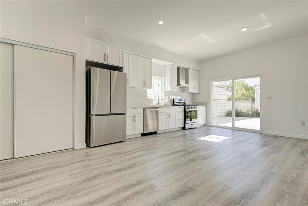 10499 Yolanda Avenue Porter Ranch, CA 91326 - Photo 7 of 37 a view of kitchen with stainless steel appliances a refrigerator and a stove top oven