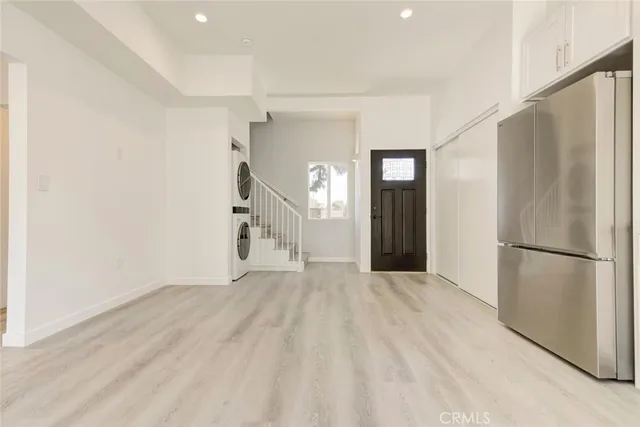 a view of a hallway with a white refrigerator