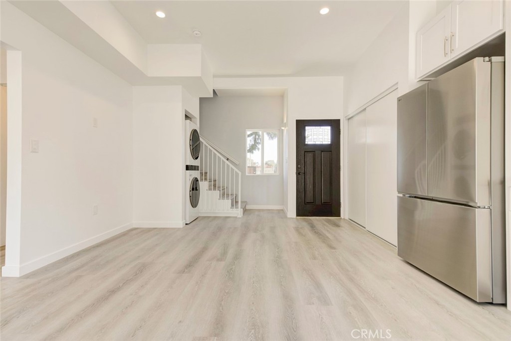 10499 Yolanda Avenue Porter Ranch, CA 91326 - Photo 8 of 37 a view of a hallway with a white refrigerator