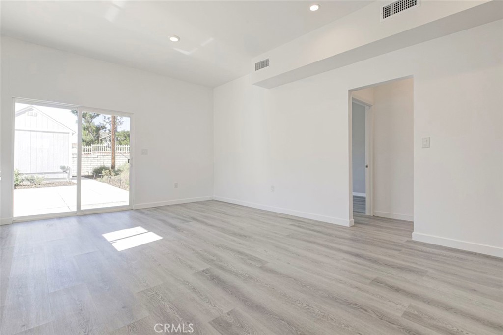 10499 Yolanda Avenue Porter Ranch, CA 91326 - Photo 10 of 37 an empty room with wooden floor and windows