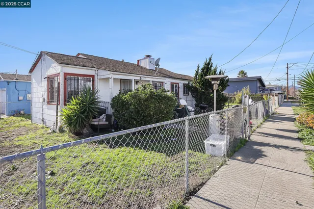 a view of a house with a small yard and plants