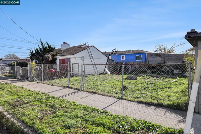a view of a house with a small yard and plants
