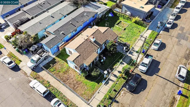 an aerial view of a house with a yard and garden