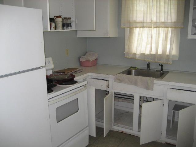 39 Otis Road Hyannis, MA 02601 - Photo 4 of 5 a kitchen with white cabinets and white appliances