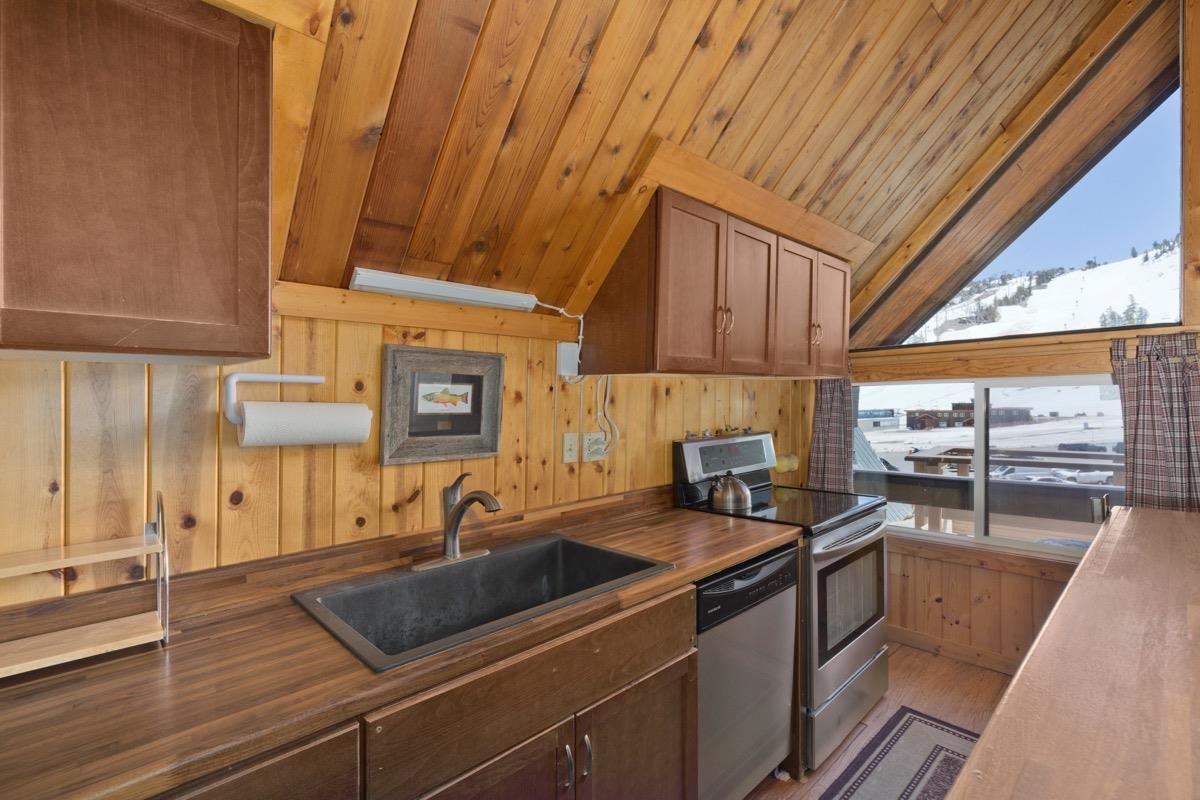 11000 Minaret Road, Unit 2 Mammoth Lakes, CA 93546 - Photo 19 of 31 a kitchen with a sink stove and cabinets