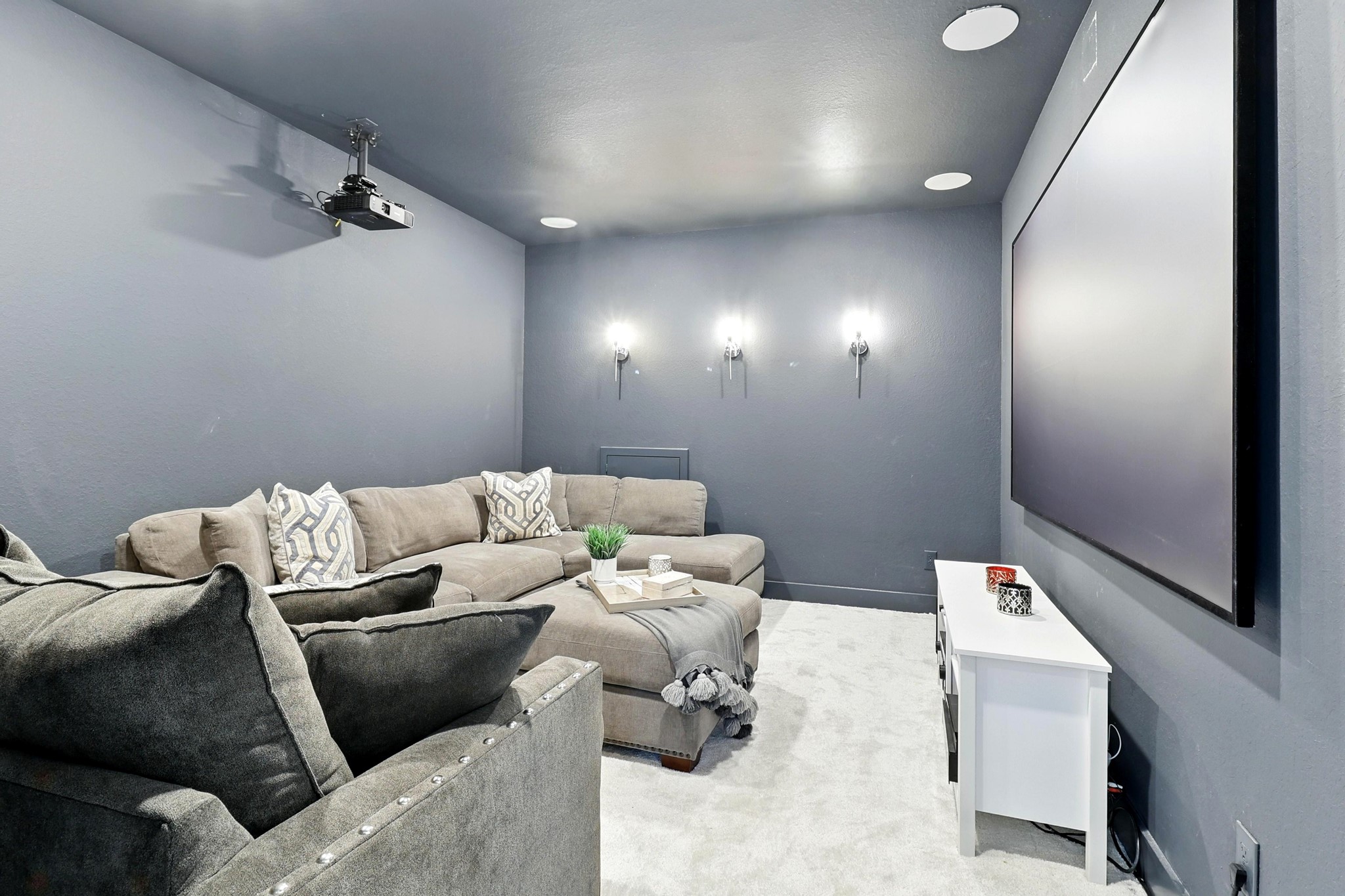 26923 Arethusa Court Spring, TX 77389 - Photo 19 of 44 Cozy home theater room with dark walls, Pre-wire for sound and video. A modern wall sconces for ambient lighting, creating an ideal space for movie nights.
