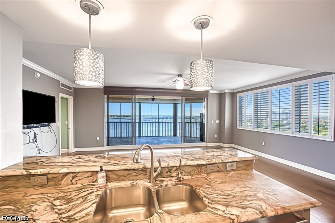 2104 West First Street, Unit 1004 Fort Myers, FL 33901 - Photo 11 of 42 a view of a dining room with furniture wooden floor and chandelier