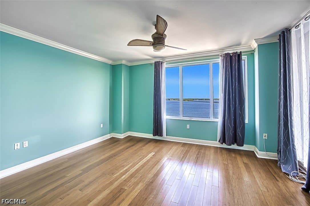 2104 West First Street, Unit 1004 Fort Myers, FL 33901 - Photo 12 of 42 wooden floor in an empty room with a window