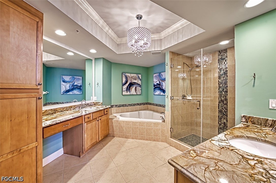 2104 West First Street, Unit 1004 Fort Myers, FL 33901 - Photo 13 of 42 a spacious bathroom with a granite countertop tub sink shower and mirror