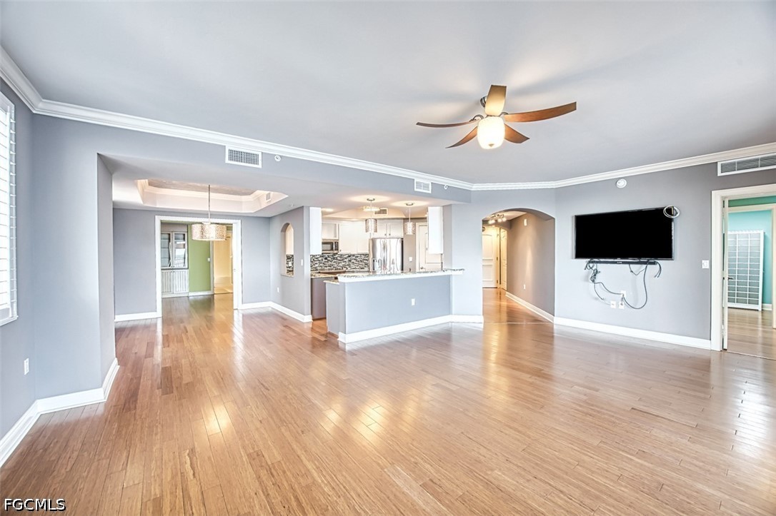 2104 West First Street, Unit 1004 Fort Myers, FL 33901 - Photo 14 of 42 a view of a livingroom with wooden floor and a ceiling fan