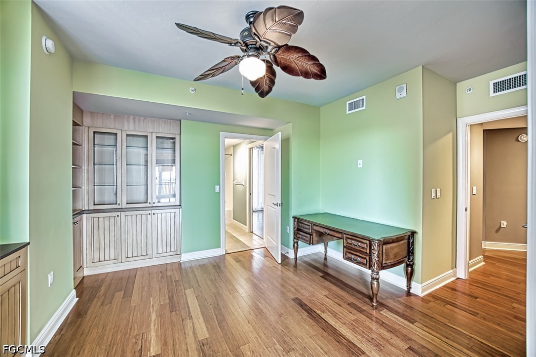 2104 West First Street, Unit 1004 Fort Myers, FL 33901 - Photo 17 of 42 a view of a room with wooden floor and ceiling fan