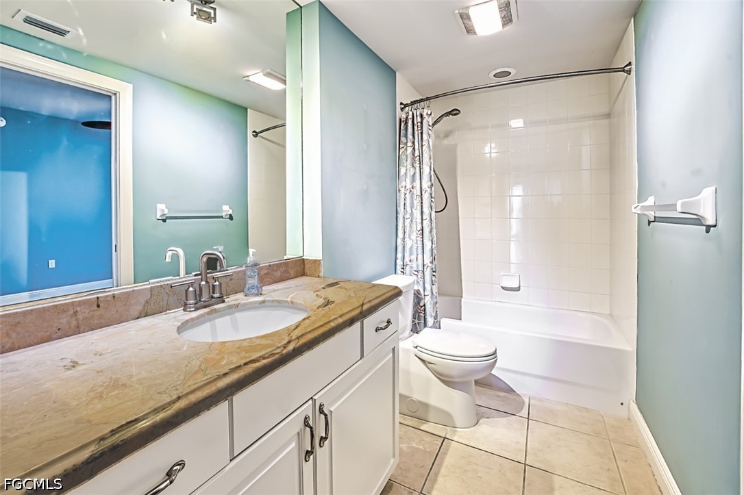 2104 West First Street, Unit 1004 Fort Myers, FL 33901 - Photo 19 of 42 a bathroom with a granite countertop sink toilet and shower