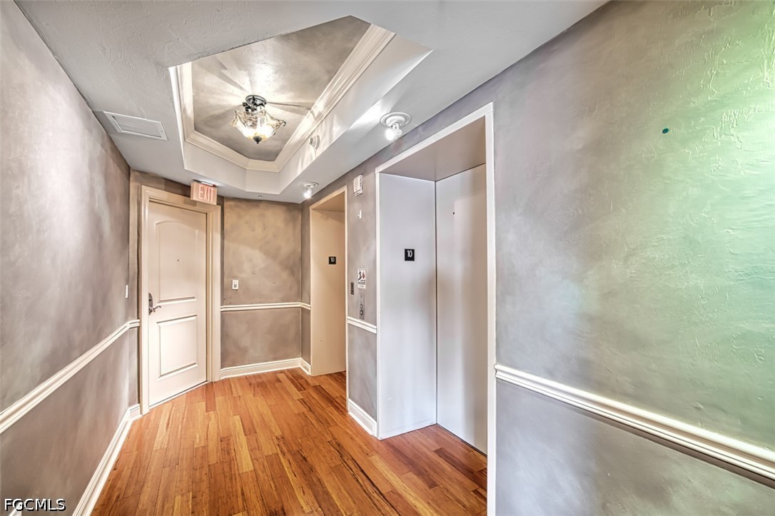 2104 West First Street, Unit 1004 Fort Myers, FL 33901 - Photo 20 of 42 a view of a hallway with wooden floor