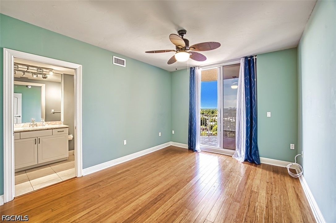 2104 West First Street, Unit 1004 Fort Myers, FL 33901 - Photo 22 of 42 a view of an empty room with wooden floor