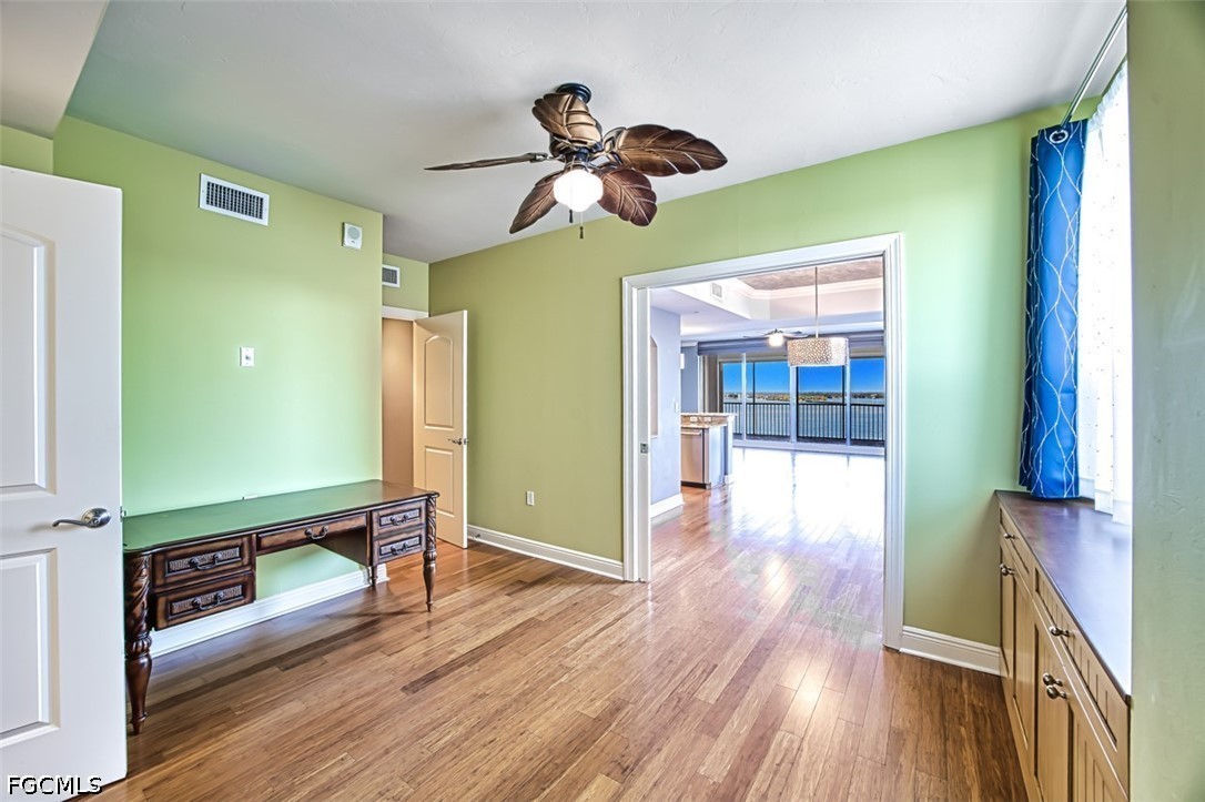 2104 West First Street, Unit 1004 Fort Myers, FL 33901 - Photo 24 of 42 a view of a room with wooden floor and ceiling fan
