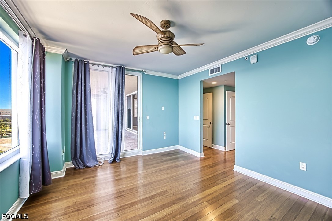 2104 West First Street, Unit 1004 Fort Myers, FL 33901 - Photo 30 of 42 an empty room with wooden floor and windows
