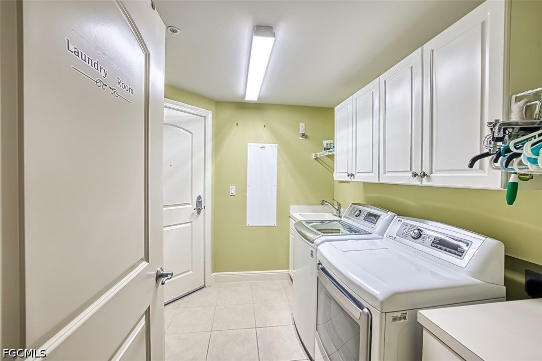 2104 West First Street, Unit 1004 Fort Myers, FL 33901 - Photo 35 of 42 a utility room with cabinets washer and dryer