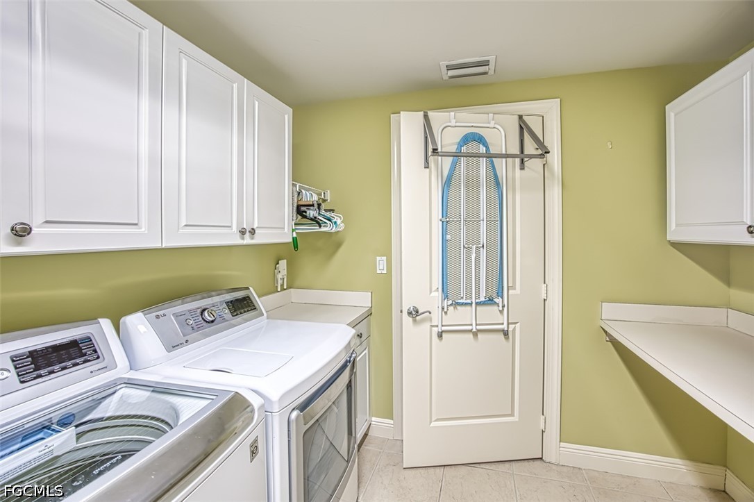 2104 West First Street, Unit 1004 Fort Myers, FL 33901 - Photo 36 of 42 a utility room with dryer and washer