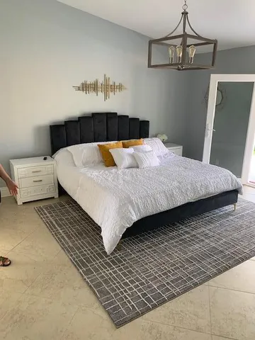 a bedroom with a bed and window