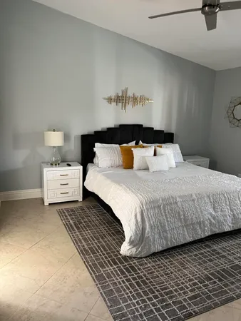 a bedroom with a large bed and a night stand