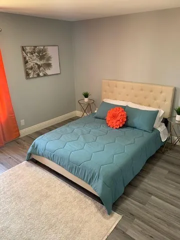 a bedroom with a bed and dresser