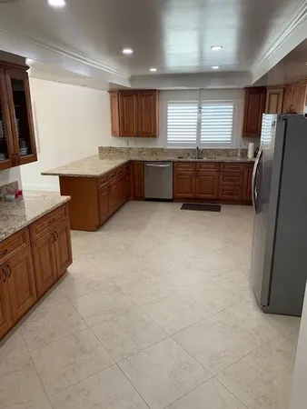 a kitchen with stainless steel appliances a refrigerator sink and microwave