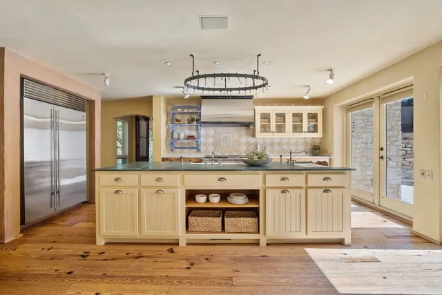 a bathroom with a granite countertop sink a mirror and a shower