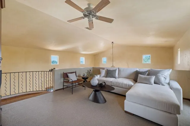 an empty room with windows and stairs
