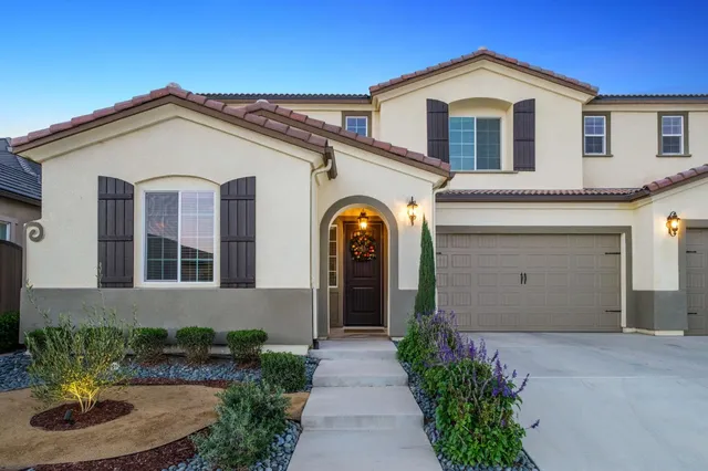 a front view of a house with garden