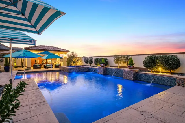 a view of a house with swimming pool and sitting area