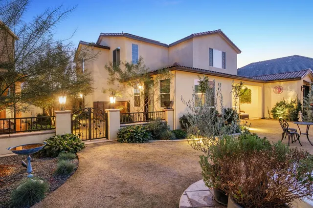 a front view of a house with a garden