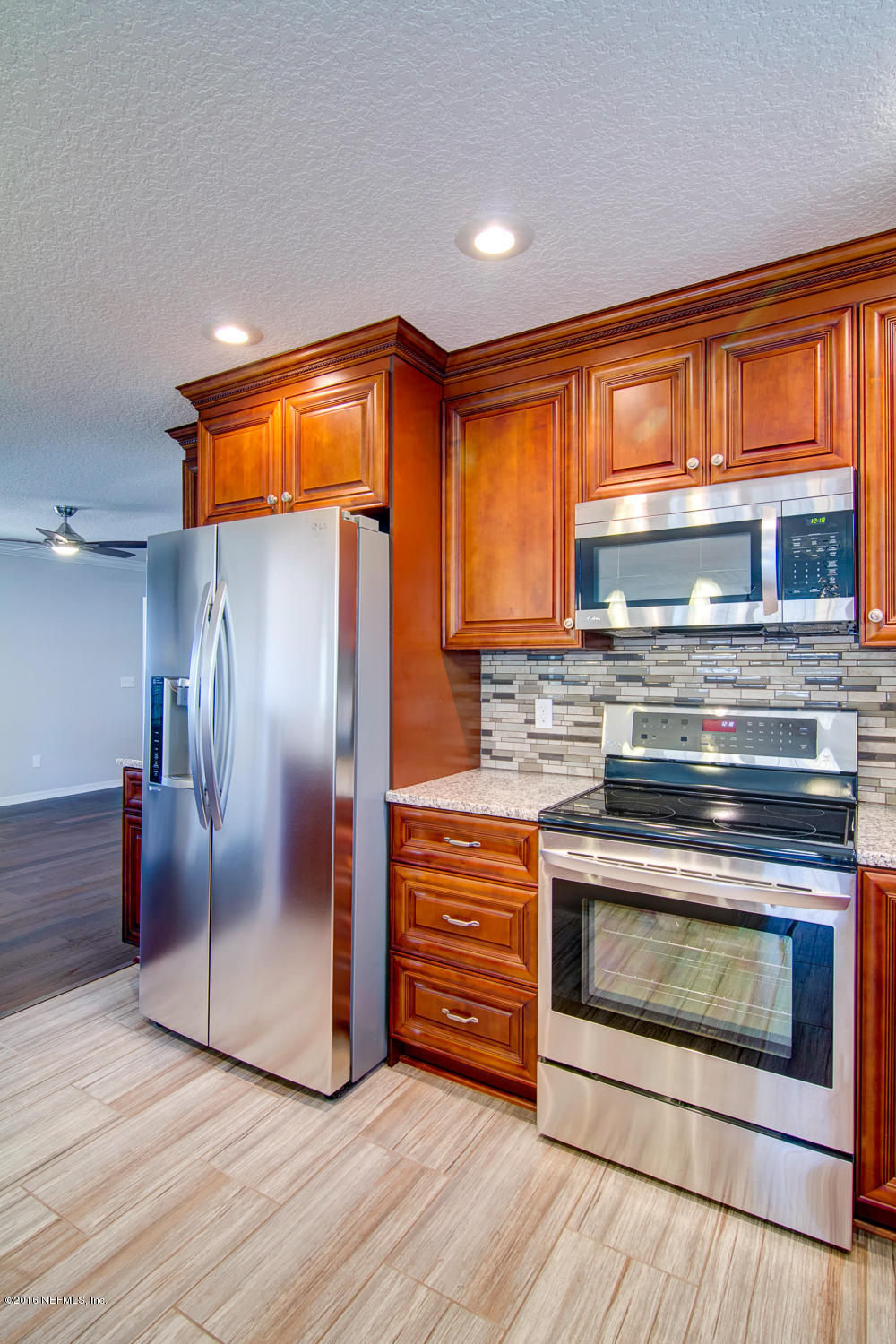 1634 Derringer Road Jacksonville, FL 32225 - Photo 13 of 41 a kitchen with granite countertop wooden floors and stainless steel appliances