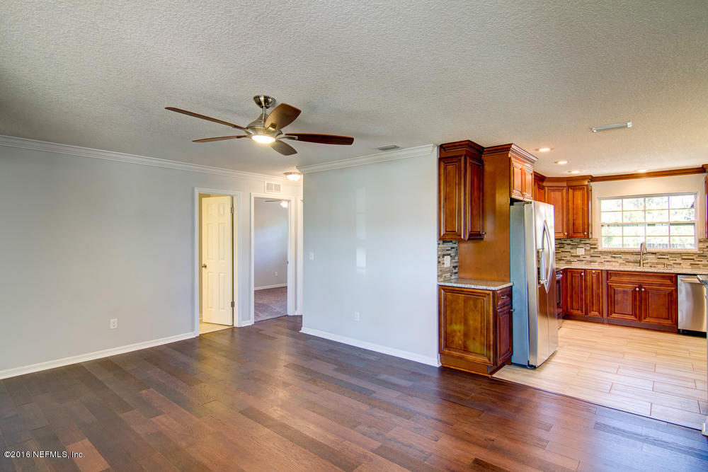 1634 Derringer Road Jacksonville, FL 32225 - Photo 14 of 41 a view of an empty room with window and wooden floor