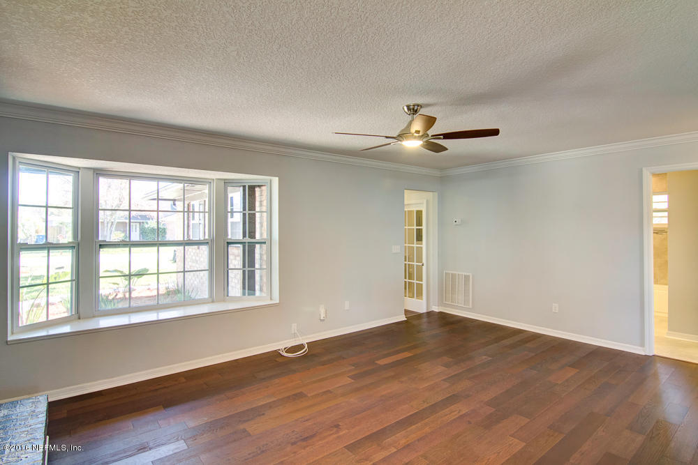 1634 Derringer Road Jacksonville, FL 32225 - Photo 17 of 41 wooden floor in an empty room with a window