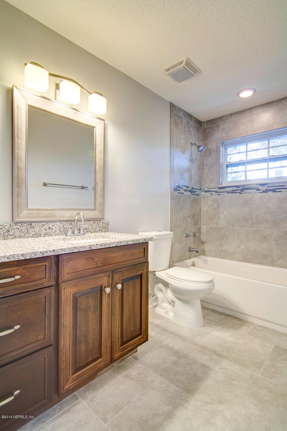 1634 Derringer Road Jacksonville, FL 32225 - Photo 18 of 41 a bathroom with a granite countertop sink a toilet and a bathtub