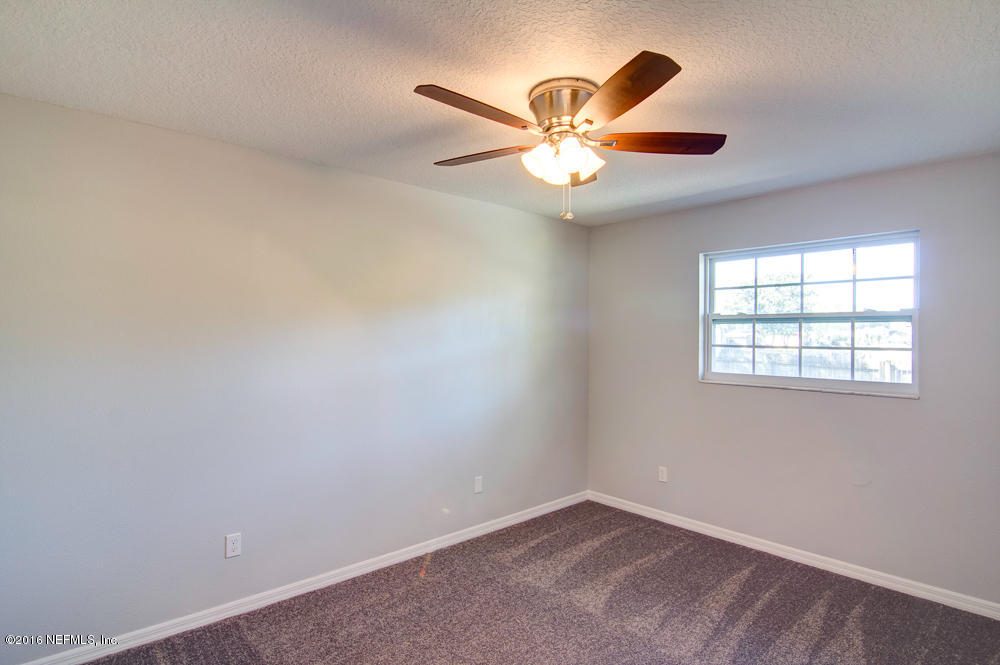 1634 Derringer Road Jacksonville, FL 32225 - Photo 28 of 41 an empty room with windows and fan